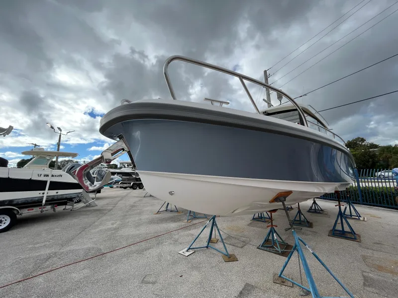 Slide: The Image of 2024 Nimbus Commuter 9 #136 boat on stands under cloudy sky. - 31