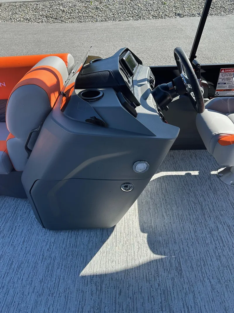 Slide: The Image of 2025 Bennington 21 SSR Quad Bench boat interior with steering console and seating. - 11