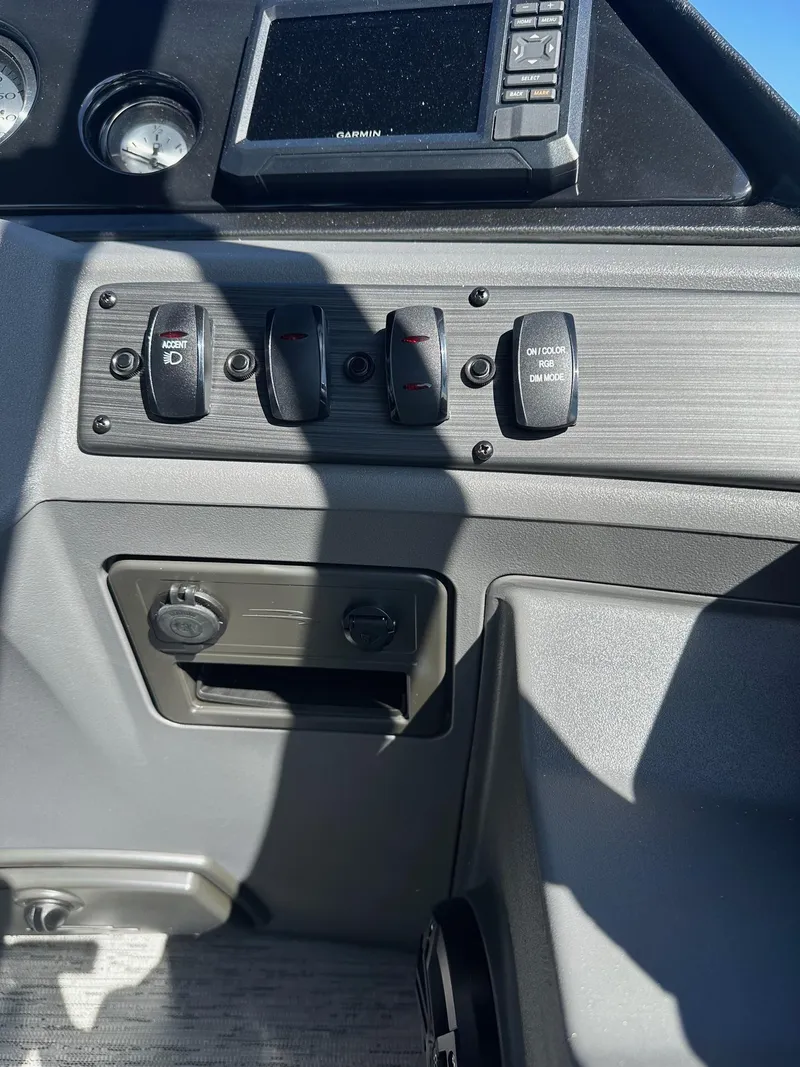 Slide: The Image of Control panel of 2025 Bennington 21 SSR Quad Bench boat with switches and display. - 13