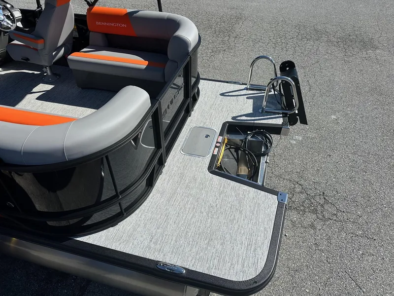 Slide: The Image of 2025 Bennington 21 SSR Quad Bench pontoon boat interior with seating and storage. - 17