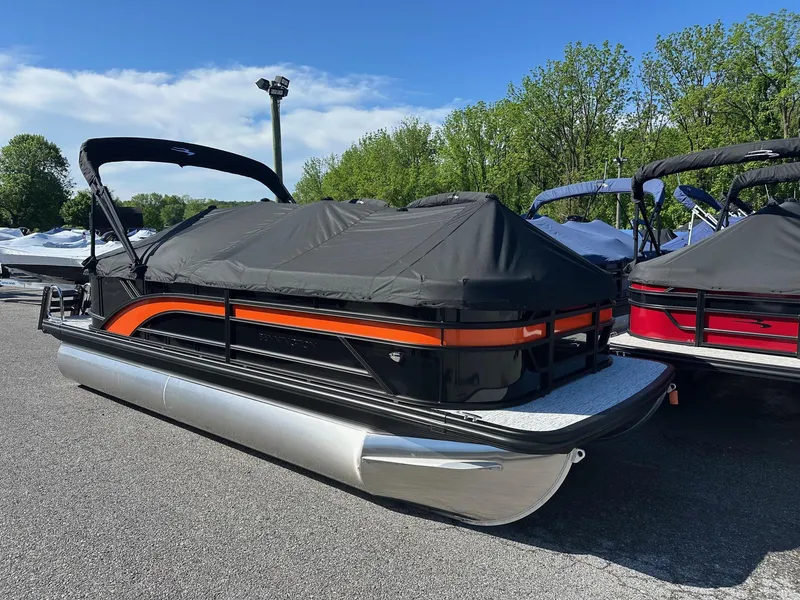 Slide: The Image of 2025 Bennington 21 SSR Quad Bench pontoon boat, covered and in stock, parked outdoors. - 20