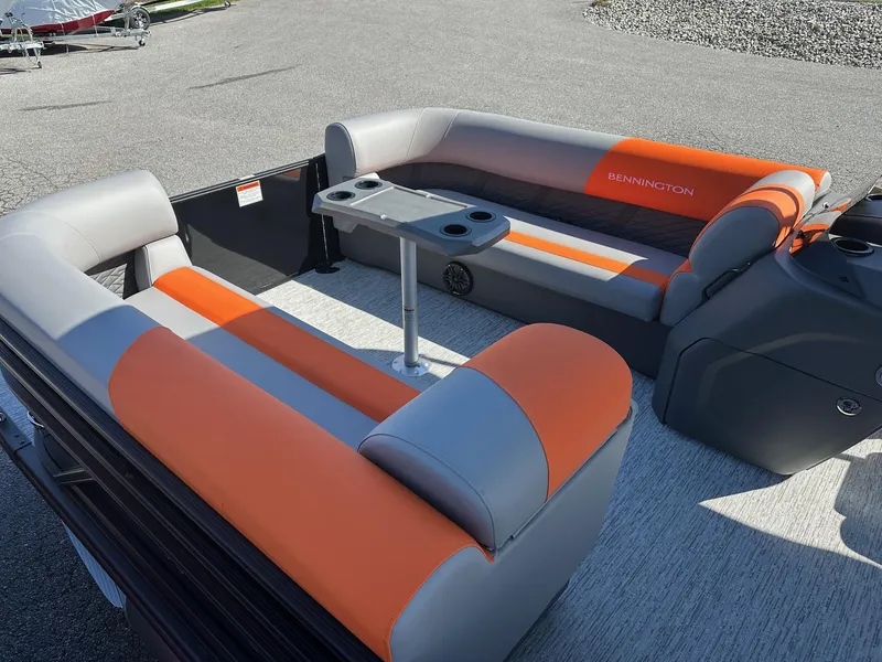 Slide: The Image of 2025 Bennington 21 SSR Quad Bench boat with orange and gray seating. - 25