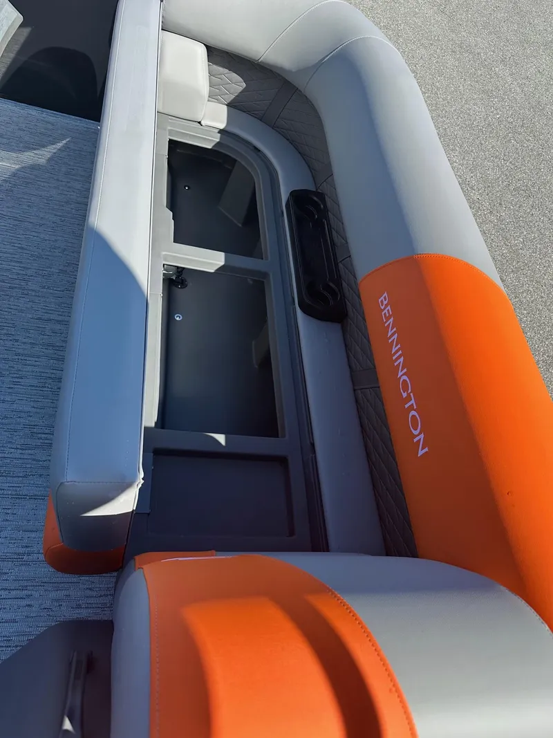 Slide: The Image of 2025 Bennington 21 SSR Quad Bench with orange and gray seating, open storage compartment. - 27