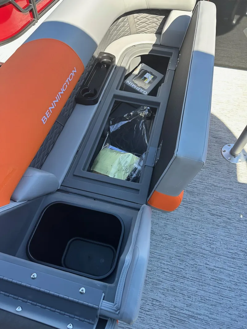 Slide: The Image of 2025 Bennington 21 SSR Quad Bench with storage compartments and orange-gray seating. - 28