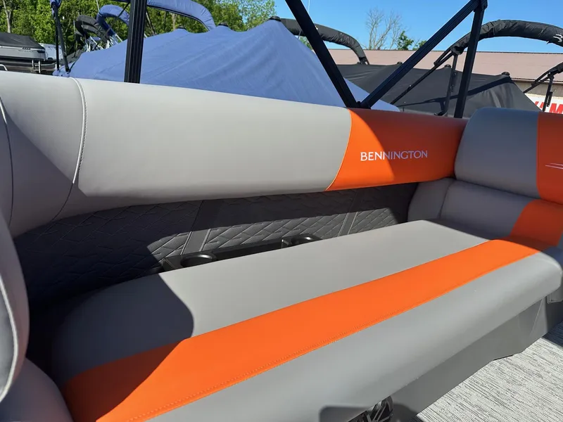 Slide: The Image of 2025 Bennington 21 SSR Quad Bench with gray and orange seating, outdoor setting. - 30