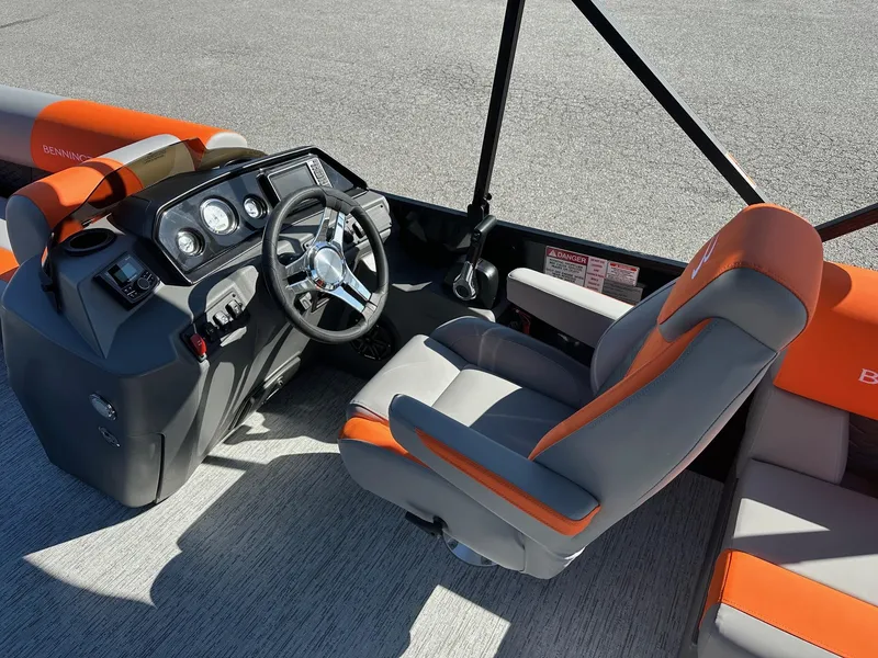 Slide: The Image of 2025 Bennington 21 SSR Quad Bench boat interior with gray and orange seating. - 35
