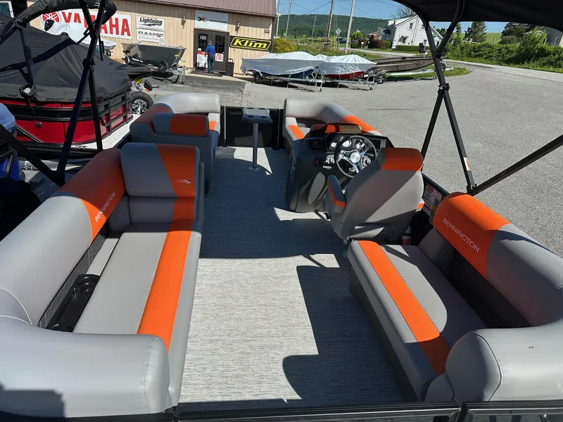 Slide: The Image of 2025 Bennington 21 SSR Quad Bench pontoon boat with orange and gray seating, in stock. - 38
