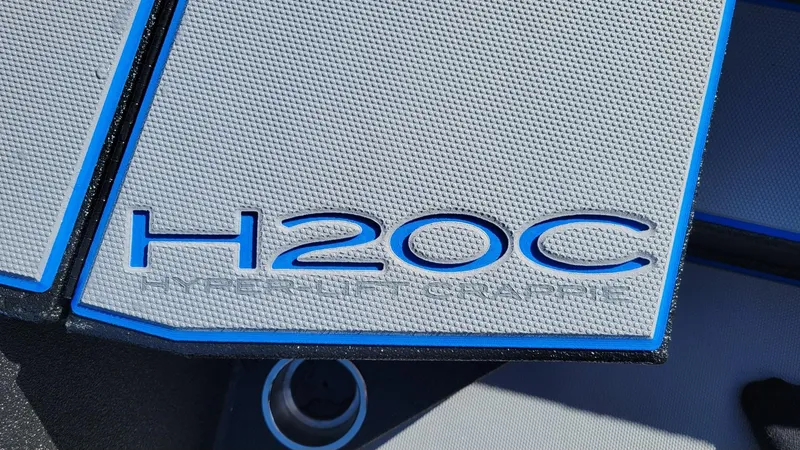 Slide: The Image of 2025 Xpress H20C Crappie boat logo with textured surface and blue accents. - 14