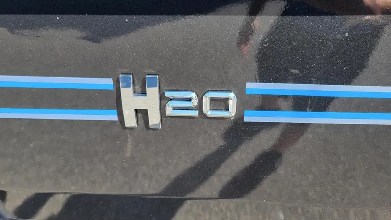 Slide: The Image of 2025 Xpress H20C Crappie boat emblem with blue stripes. - 3