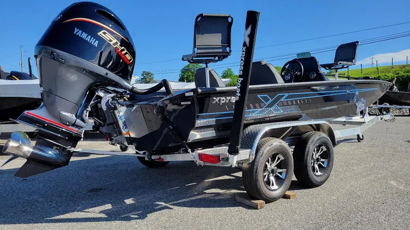 Slide: The Image of 2025 Xpress H20C Crappie boat with Yamaha Vmax 175 engine, parked on trailer. - 4