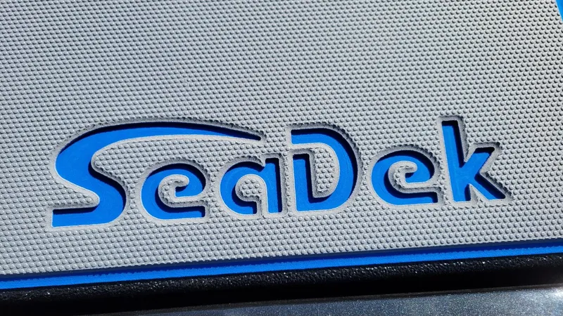 Slide: The Image of SeaDek logo on textured surface, featured on 2025 Xpress H20C Crappie boat. - 6