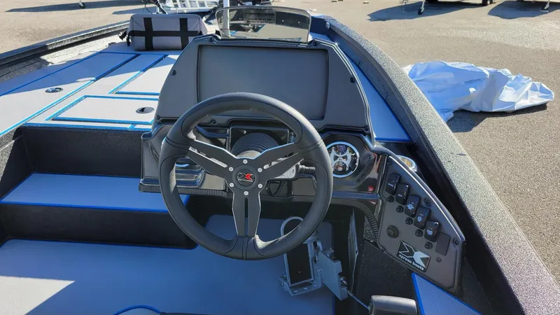 Slide: The Image of 2025 Xpress H20C Crappie boat interior with steering wheel and control panel. - 7