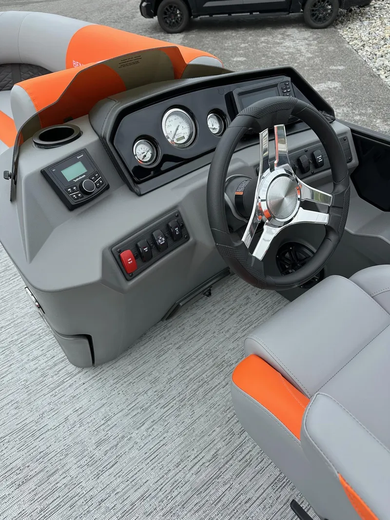 Slide: The Image of 2025 Bennington 22 SSB Swing Back boat dashboard with steering wheel and controls. - 12