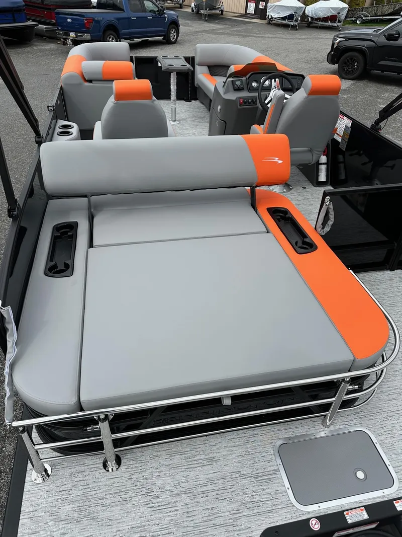 Slide: The Image of 2025 Bennington 22 SSB Swing Back pontoon boat with gray and orange seating. - 17