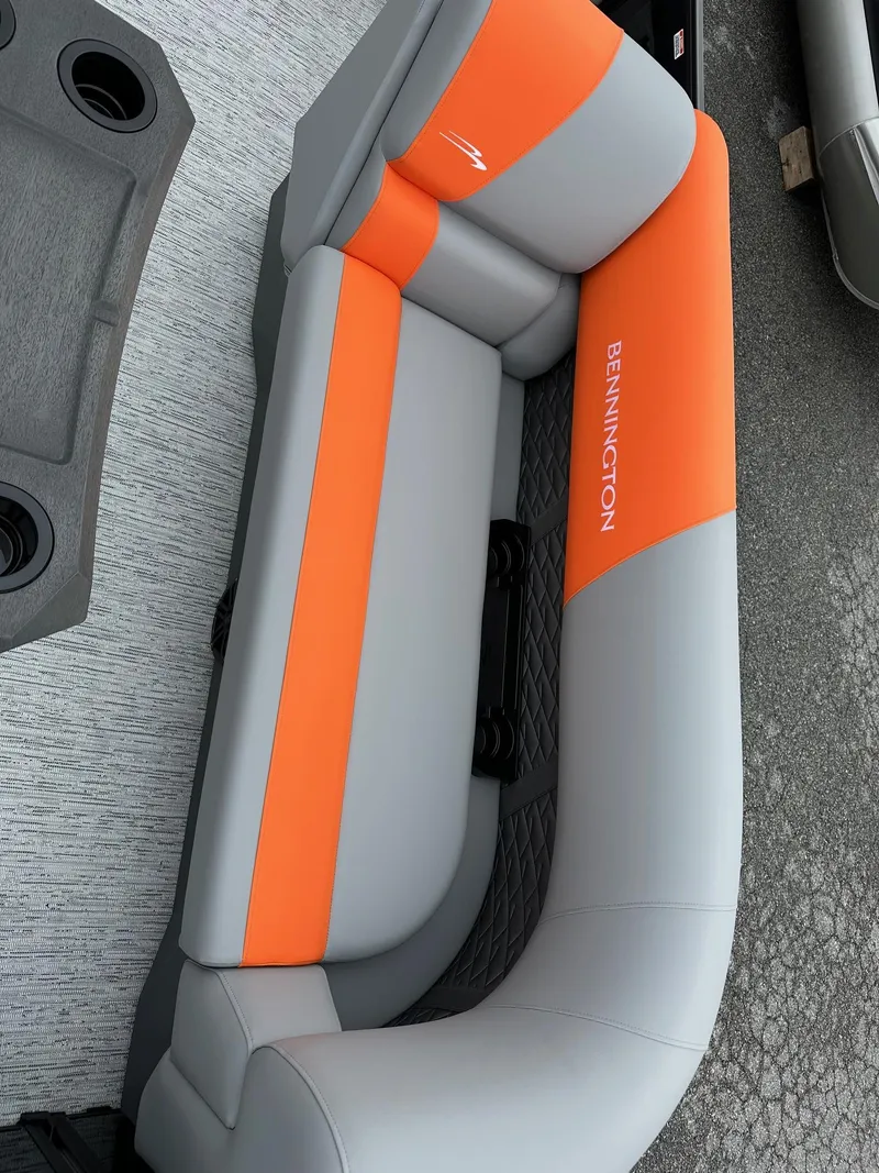 Slide: The Image of 2025 Bennington 22 SSB Swing Back boat seat, orange and gray upholstery. - 20