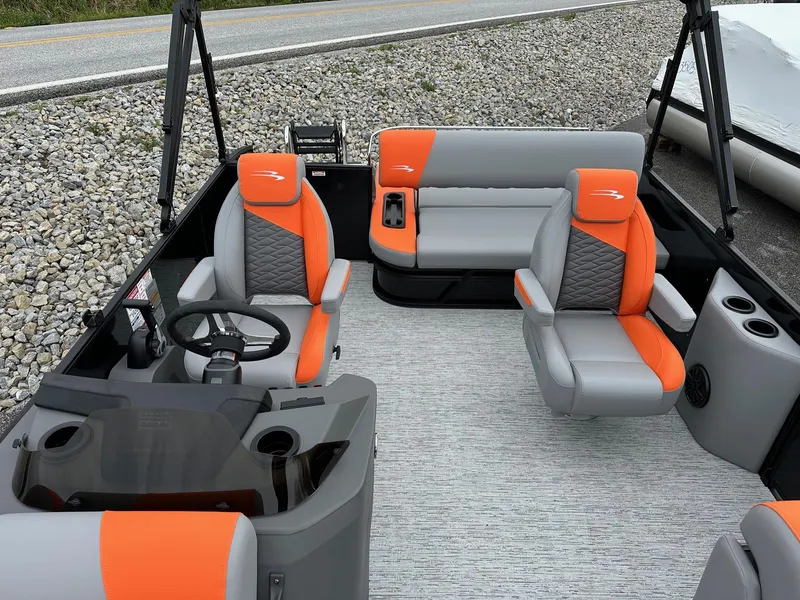 Slide: The Image of 2025 Bennington 22 SSB Swing Back boat interior with orange and gray seating. - 22