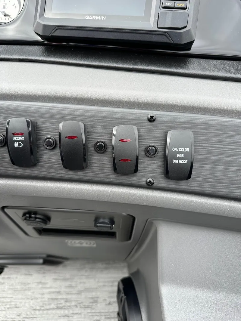 Slide: The Image of Control panel of 2025 Bennington 22 SSB Swing Back boat with switches and Garmin display. - 28