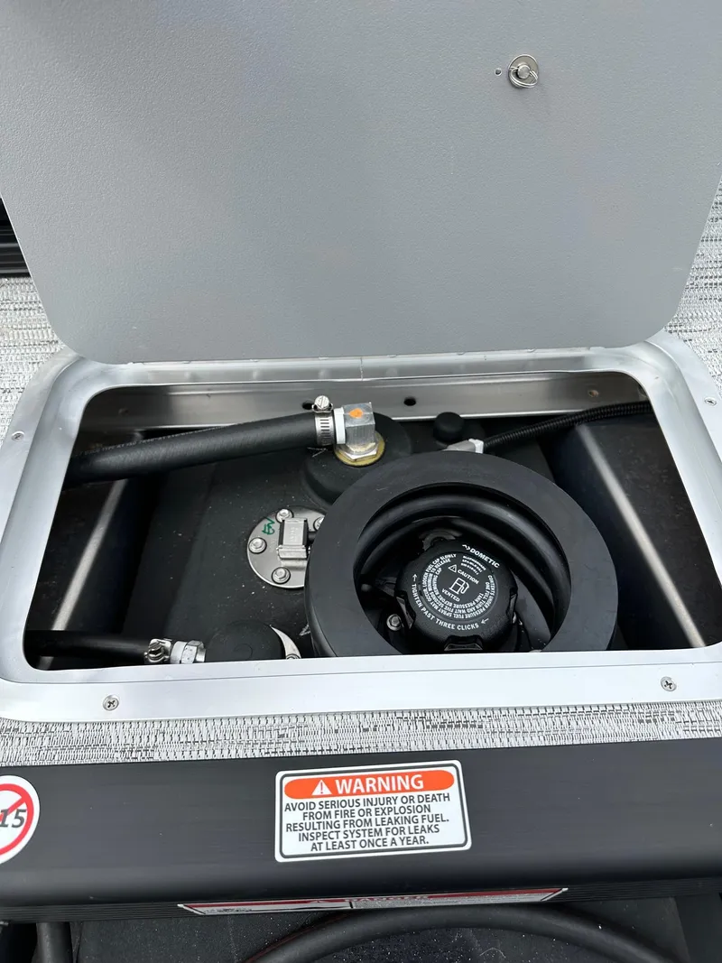 Slide: The Image of Fuel compartment of 2025 Bennington 22 SSB Swing Back boat with safety warning label. - 34