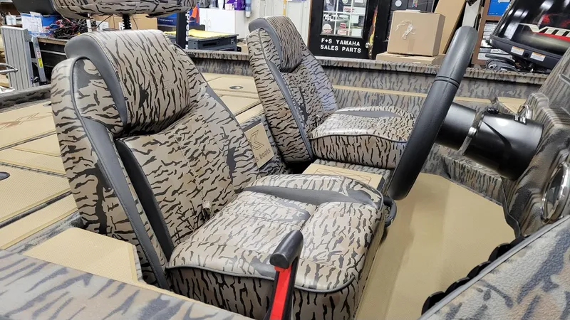 Slide: The Image of 2025 Xpress H18 Bass boat interior with patterned seats and steering wheel. - 12