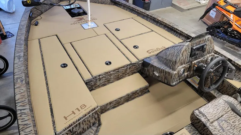 Slide: The Image of 2025 Xpress H18 Bass boat interior with Yamaha Vmax 115, featuring camo design and SeaDek flooring. - 13