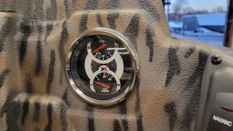 Slide: The Image of Fuel and pressure gauges on 2025 Xpress H18 Bass boat dashboard with camouflage pattern. - 3