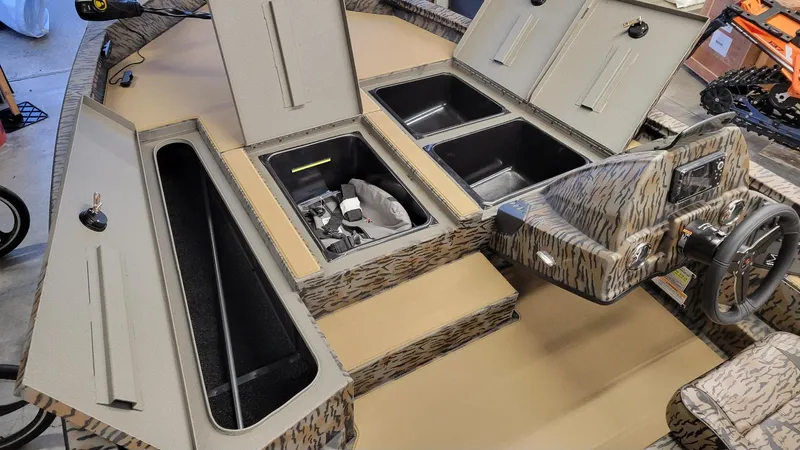 Slide: The Image of 2025 Xpress H18 Bass boat interior with storage compartments and steering console. - 5