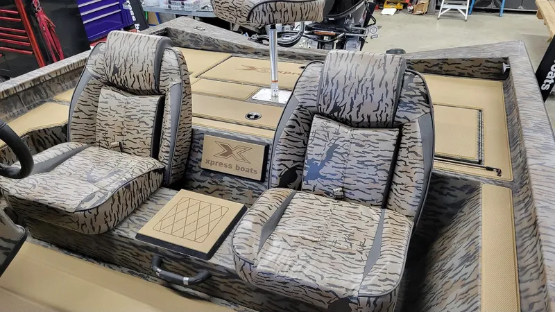 Slide: The Image of 2025 Xpress H18 Bass boat interior with camo seats and Yamaha Vmax 115 engine. - 8