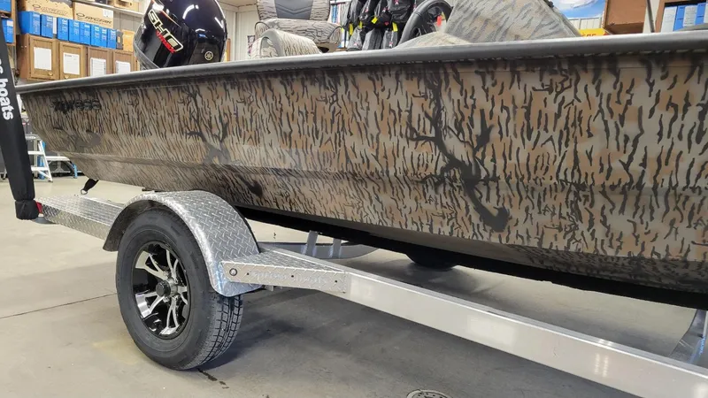 Slide: The Image of 2025 Xpress H18 Bass boat with Yamaha Vmax 115, camo design, on trailer in stock. - 9