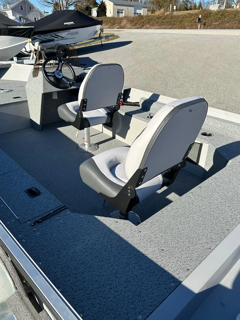Slide: The Image of 2025 Smoker Craft 16 Angler Patriot SC fishing boat interior with two seats and steering console. - 13