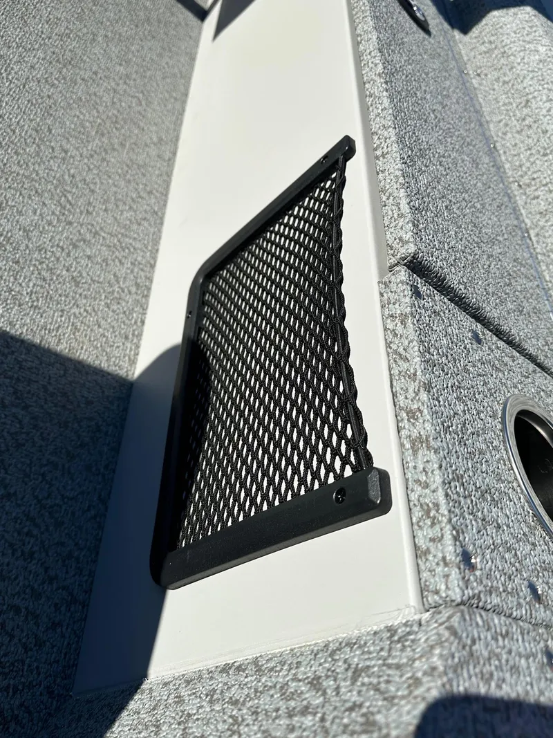 Slide: The Image of 2025 Smoker Craft 16 Angler Patriot SC fishing boat interior with storage netting. - 19