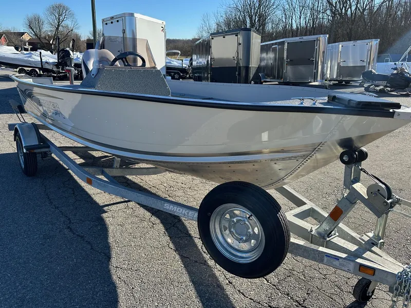 Slide: The Image of 2025 Smoker Craft 16 Angler Patriot SC fishing boat on trailer, parked outdoors. - 20