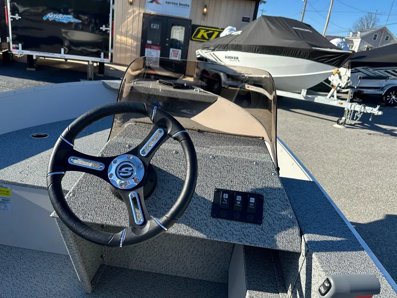 Slide: The Image of 2025 Smoker Craft 16 Angler Patriot SC fishing boat interior with steering wheel. - 6