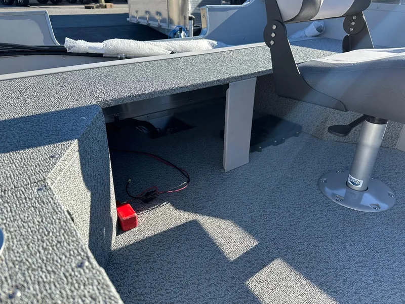 Slide: The Image of 2025 Smoker Craft 16 Angler Patriot SC fishing boat interior with seating and storage. - 7