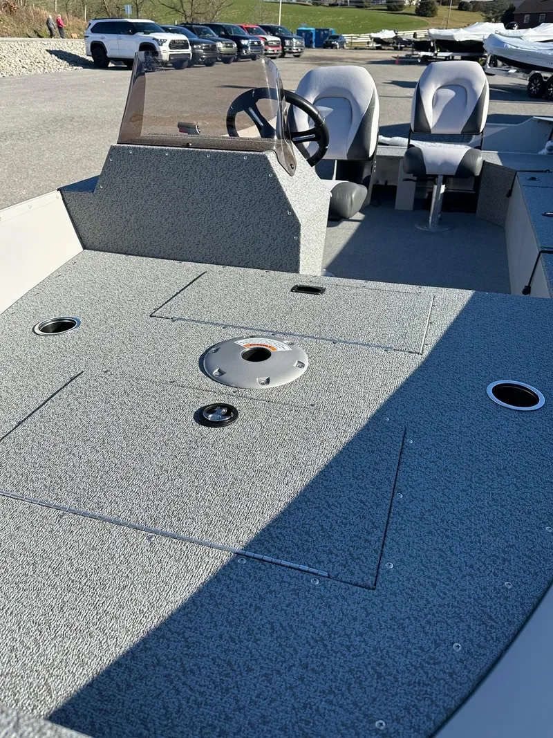 Slide: The Image of 2025 Smoker Craft 16 Angler Patriot SC fishing boat interior, featuring seating and steering console. - 8