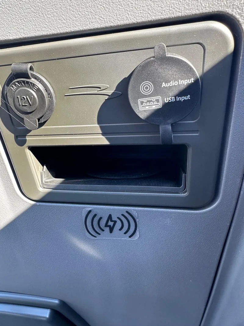 Slide: The Image of Dashboard of 2025 Bennington Tritoon with 12V, audio, USB inputs, and wireless charging. - 14