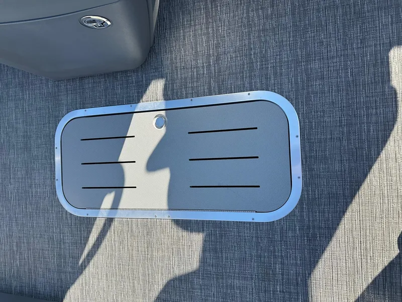 Slide: The Image of 2025 Bennington 20 SSB Tritoon deck detail with textured flooring and hatch. - 17