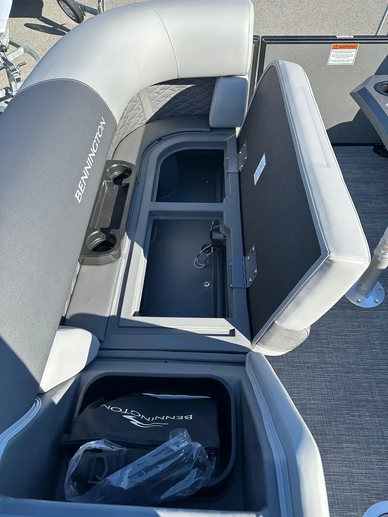 Slide: The Image of 2025 Bennington 20 SSB Tritoon storage compartments with open seats and visible branding. - 20