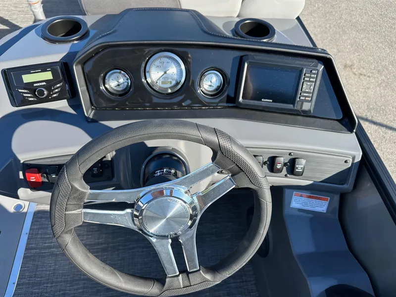 Slide: The Image of 2025 Bennington 20 SSB Tritoon dashboard with steering wheel, gauges, and Garmin display. - 8
