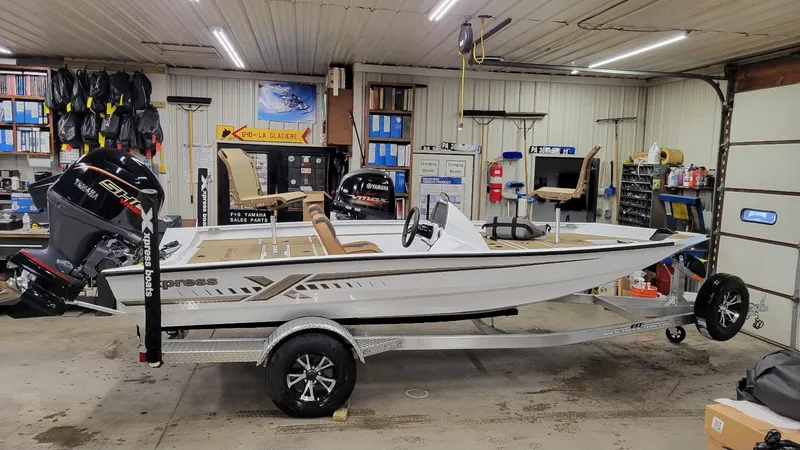 The Image of 2025 Xpress H18C Crappie boat with Yamaha Vmax 115 in a garage setting. - 1