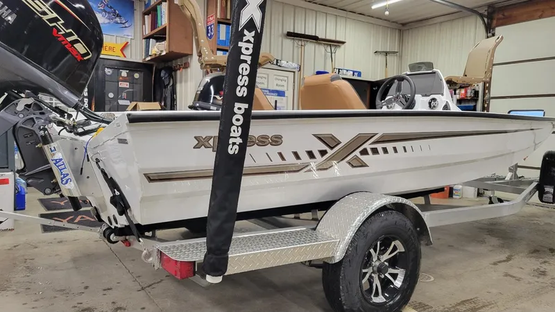 Slide: The Image of 2025 Xpress H18C Crappie boat with Yamaha Vmax 115 in a garage setting. - 11