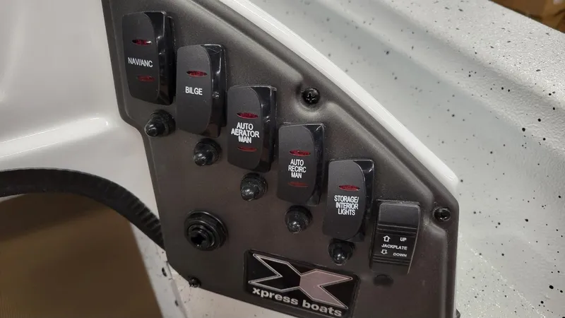 Slide: The Image of Control panel of 2025 Xpress H18C Crappie boat with labeled switches. - 15