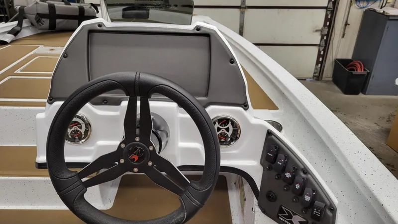 Slide: The Image of 2025 Xpress H18C Crappie boat dashboard with steering wheel and controls. - 16