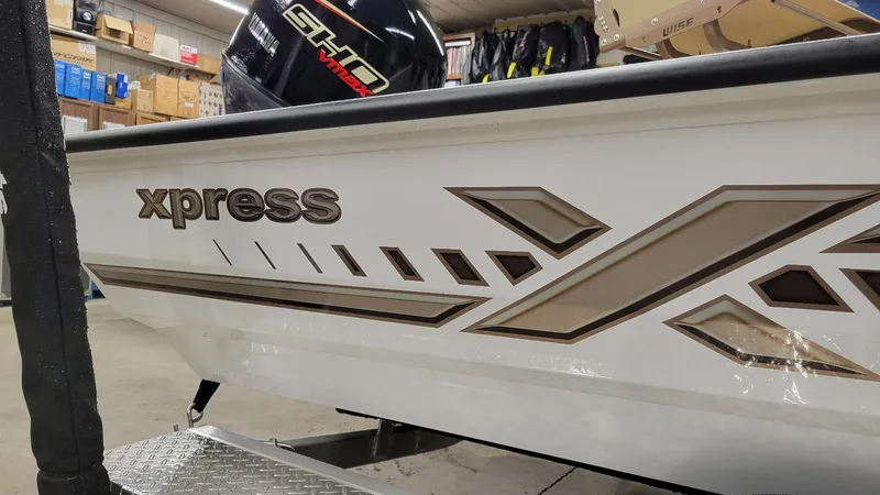 Slide: The Image of 2025 Xpress H18C Crappie boat with Yamaha Vmax 115 engine in showroom. - 3