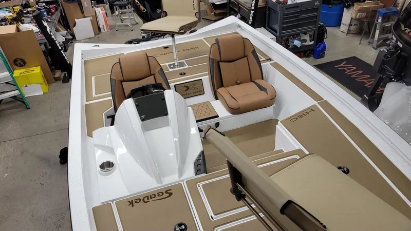 Slide: The Image of 2025 Xpress H18C Crappie boat interior with Yamaha Vmax 115, featuring tan seating and deck. - 7