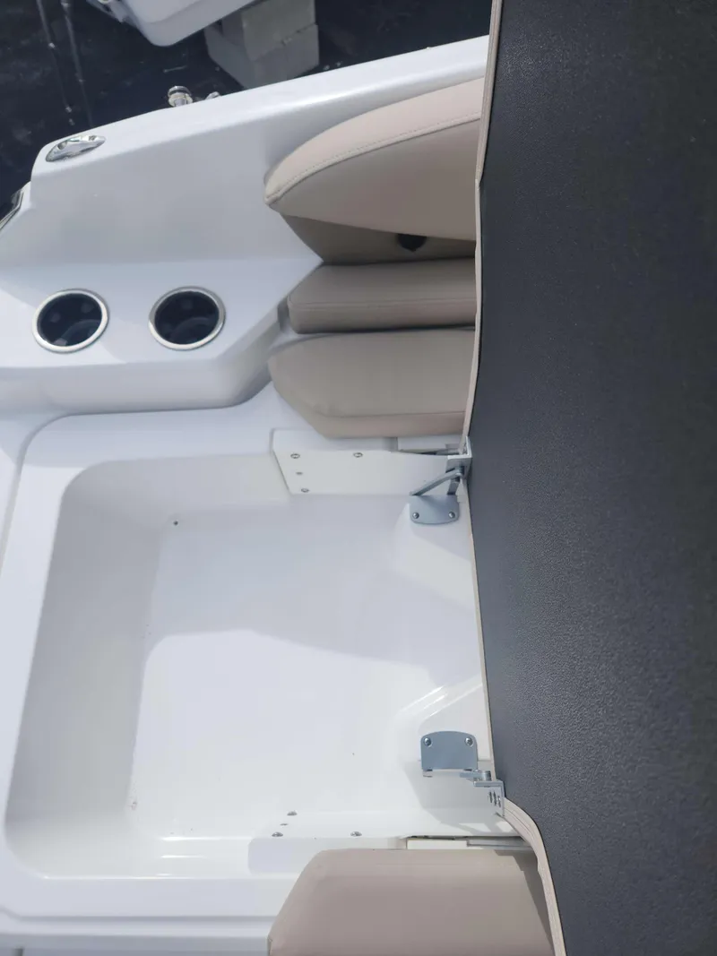 Slide: The Image of 2024 Hurricane 2600 SD boat seating area with cup holders and storage compartment. - 4