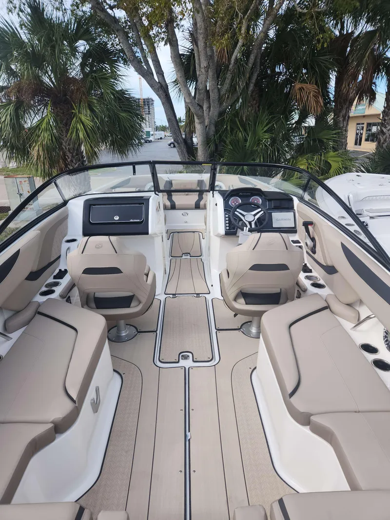 Slide: The Image of 2024 Hurricane 2600 SD boat interior with beige seating and modern dashboard. - 7