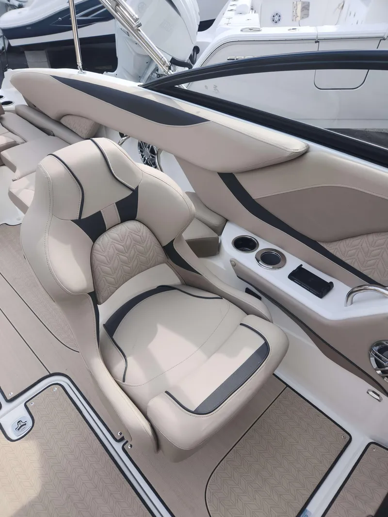 Slide: The Image of 2024 Hurricane 2600 SD boat interior with beige and black captain's chair. - 9
