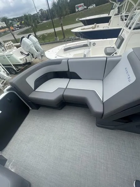 Slide: The Image of 2024 Manitou 22 Cruise Flebrf Stealth boat with modern seating arrangement. - 10