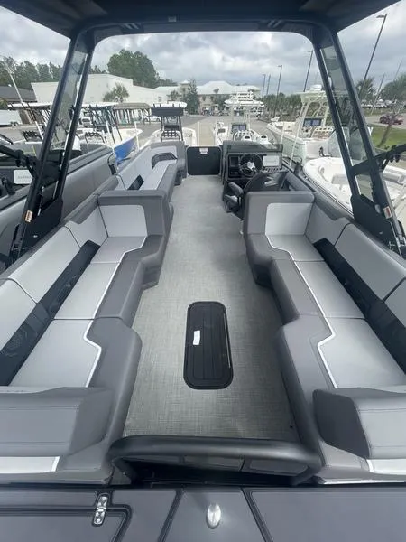 Slide: The Image of 2024 Manitou 22 Cruise Flebrf Stealth pontoon boat interior with spacious seating. - 11
