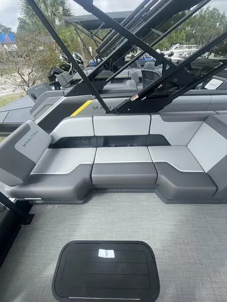 Slide: The Image of 2024 Manitou 22 Cruise FLEBRF Stealth pontoon boat interior with gray seating. - 12